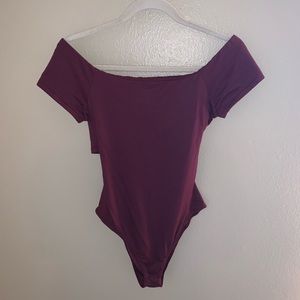Lush maroon body suit with cross detail in back.